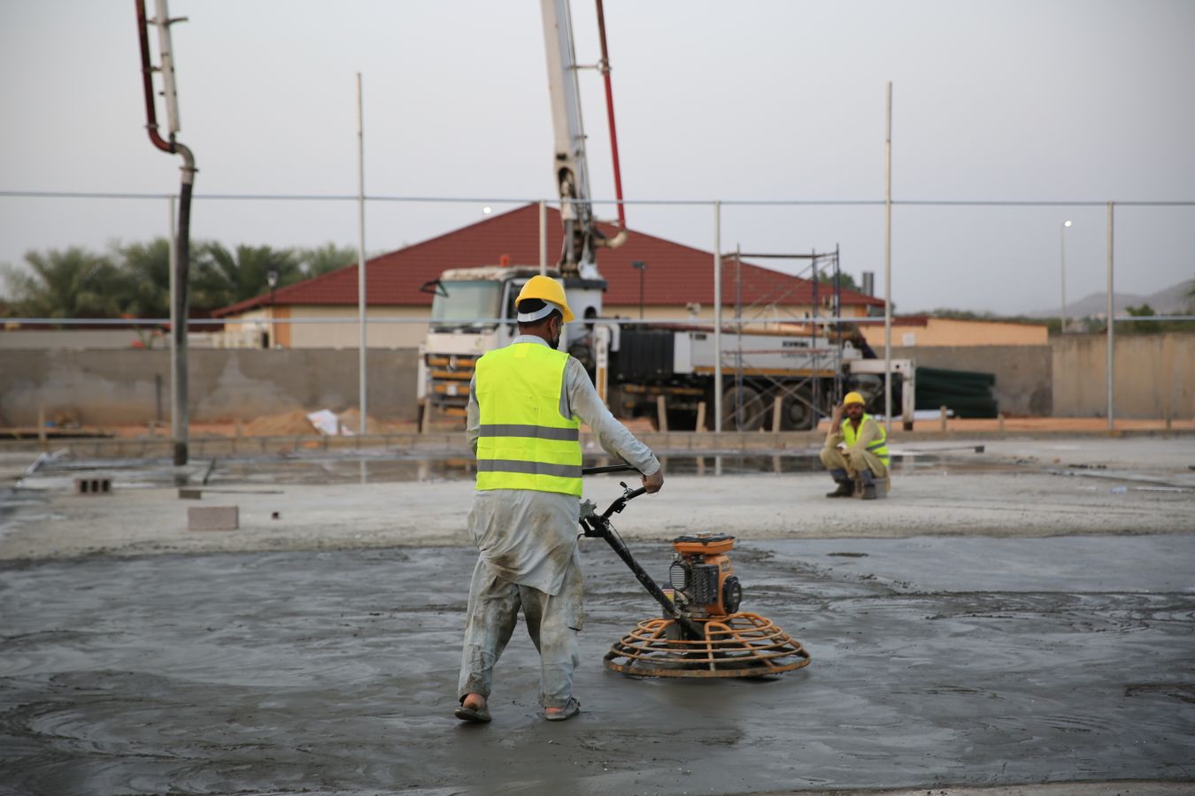 Concrete finisher working a freshly placed slab